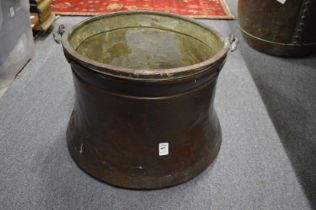 A large Eastern copper and wrought iron cooking pot.