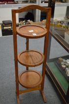 An oak three-tier folding cake stand.