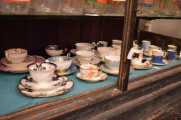 A collection of tea and coffee cups with saucers, some trio's.