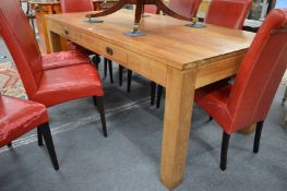 A good solid hardwood rectangular dining table with two frieze drawers.