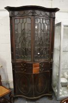 An impressive Chippendale Revival mahogany serpentine fronted cupboard bookcase with secretaire