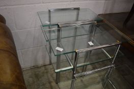 A pair of stylish glass and chrome two-tier lamp/occasional tables.