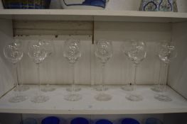 A set of twelve elegant wine glasses.