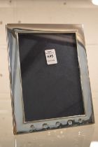 A Carrs plain silver photograph frame, photo size 7" x 5".