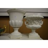 Two white glazed pottery urns.