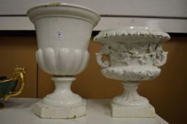 Two white glazed pottery urns.