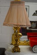 A pair of gilded plaster table lamps with shades.