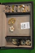 A collection of jewellery in a small jewellery box.