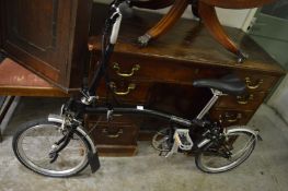 A good Brompton black painted folding bicycle.