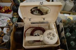 Two boxed Bakelite hair dryers and a Bakelite mantel clock.