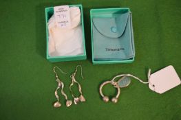 Tiffany & Co, a silver key ring with original pouch and box together with a pair of silver earrings,