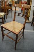 A 19th century mahogany and cane seated occasional chair.