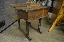 An old pine and cast iron school desk.