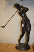 Bronze figure of a golfer.