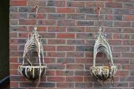 A pair of metal hanging baskets.