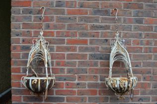 A pair of metal hanging baskets.