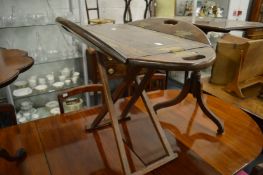 A butlers style tray top table with folding flaps.