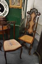 A high back cane seated hall chair together with another chair.