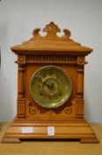 An oak cased mantel clock.