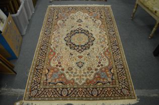 A Persian part silk rug, cream ground with stylised floral decoration 189cm x 125cm.