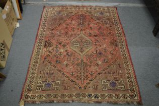 A Persian carpet, pink ground with stylised decoration including birds and trees 153cm x 117cm.