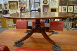 A reproduction mahogany and rosewood banded oval coffee table on sabre legs.