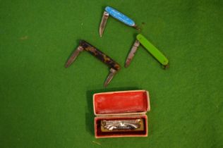 Three miniature pen knives and a boxed miniature harmonium (little band master).
