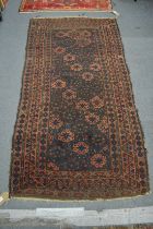 A Persian carpet, rust ground with stylised decoration 186cm x 96cm.