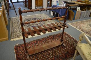 A Victorian mahogany hunting boot and whip rack.