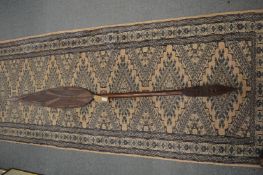 An African carved wood paddle.