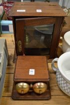 A mahogany smokers cabinet and mahogany and brass bell ringer.