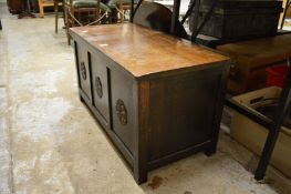 An oak blanket box containing a large quantity sewing equipment.