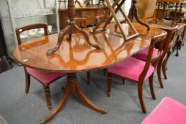 A 19th century mahogany twin pillar dining table with two leaves.