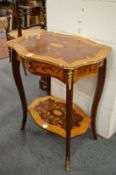 A decoratively inlaid two-tier single drawer occasional table.