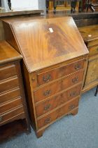 20A small reproduction mahogany bureau.