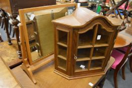 A small hanging corner cabinet and an oak framed dressing table mirror.