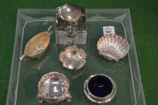 Silver condiments and a silver topped glass inkwell.