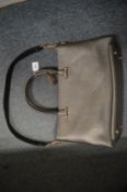 An Amanda Wakeley grey leather handbag.