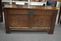An 18th century oak coffer with later top.