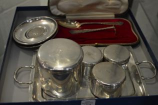 A small twin handled tray engraved with a crest together with a similar dressing