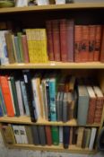 Three shelves of assorted books.