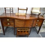 A large George III mahogany serpentine fronted sideboard.