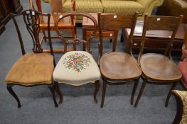 A pair of bentwood chairs and two other chairs.