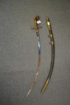 A Scimitar with horn handle, etched and blued steel blade with leather covered scabbard and brass