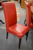 A set of eight red leather upholstered dining chairs (faults).