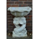 A white painted composite stone water feature.