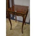 A decorative French style occasional table.