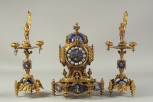 A VERY GOOD 19TH CENTURY FRENCH GILT METAL AND BLUE ENAMEL THREE PIECE CLOCK GARNITURE, the clock