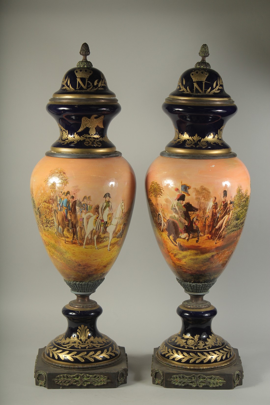 A LARGE PAIR OF PORCELAIN NAPOLEONIC VASES with an all round design of Napoleon. 34ins high.
