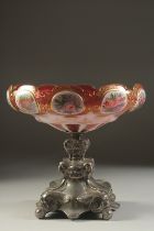 A GOOD SILVER PLATE AND BOHEMIAN GLASS DISH enamelled with ovals of flowers. 8ins high.